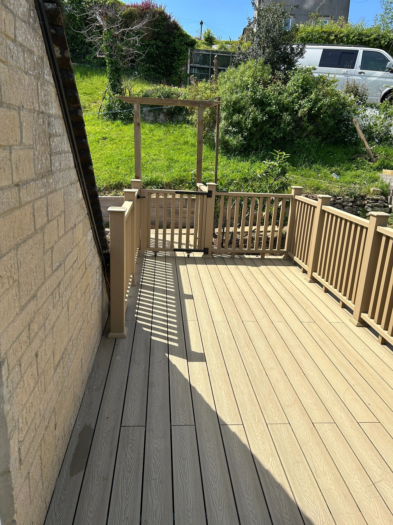 Finished raised composite decking terrace with matching balustrades in Gloucestershire
