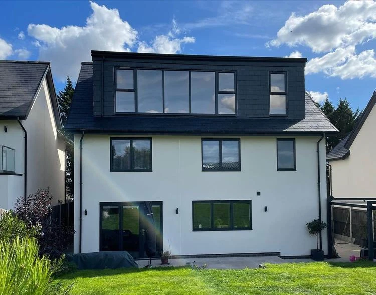 Rear dormer with dark cladding and a broad glazed opening