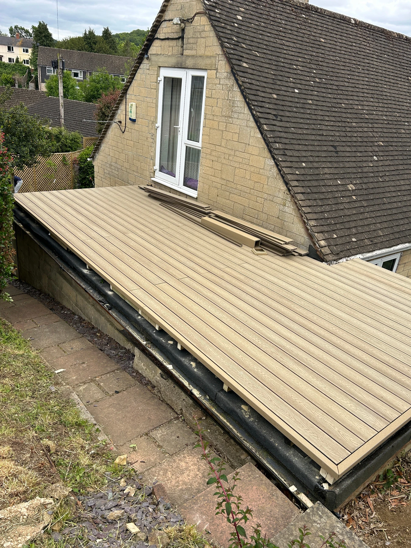 Composite decking boards being installed with hidden fixing clips
