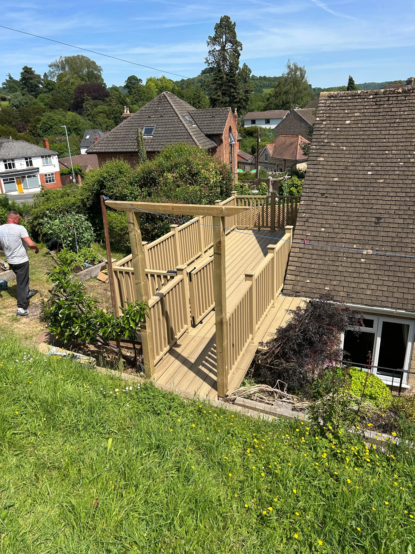 Composite balustrade posts being installed around a raised decking area
