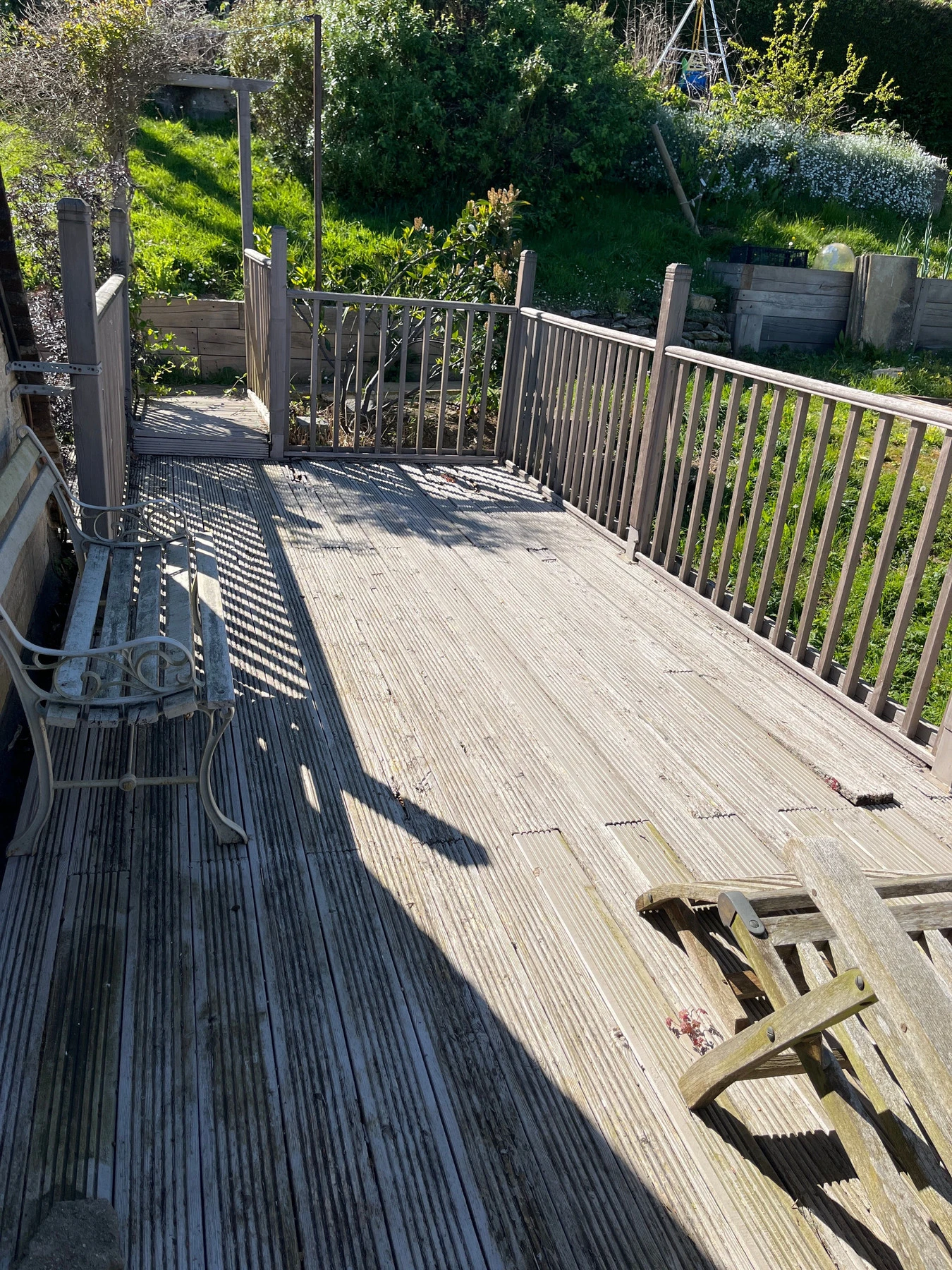 Old weathered timber decking before replacement with composite decking

