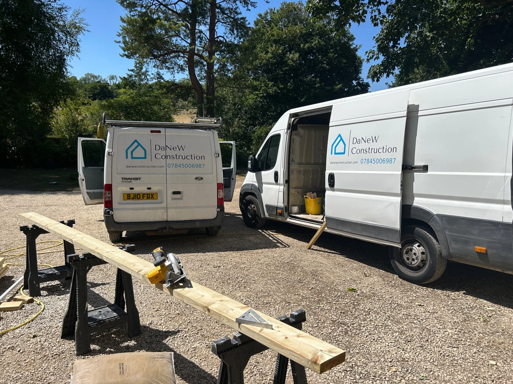 DaNeW Construction branded vans and timber preparation at a real job site